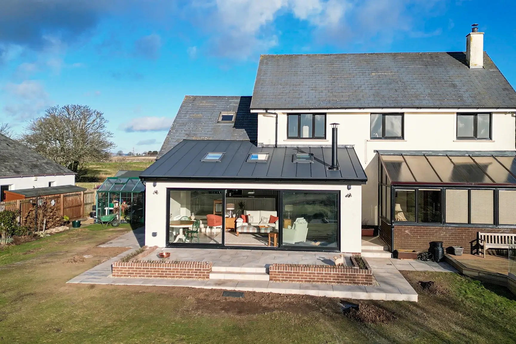 Contemporary rear extension with wide glazed doors at a renovated home in West Kilbride, Ayrshire