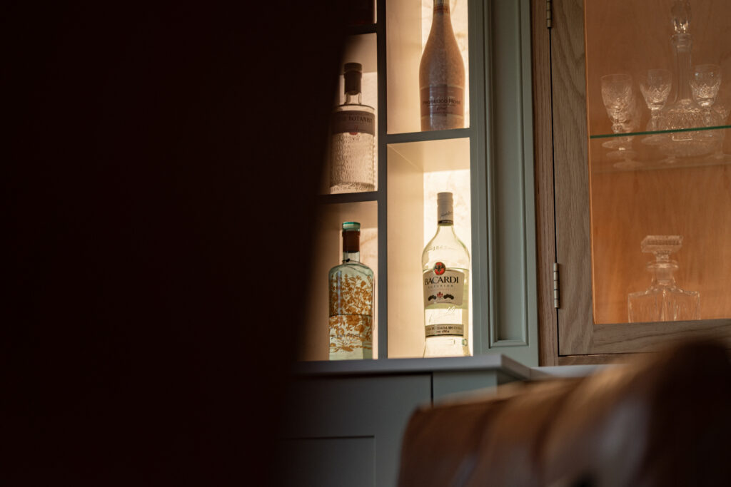 Bespoke bar cabinetry with lit glass-fronted shelves in a period home renovation in Alloway, Ayrshire